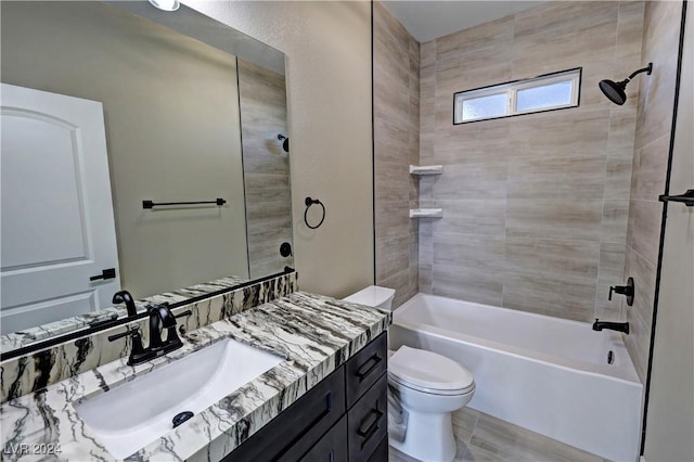 full bathroom featuring vanity, tiled shower / bath combo, and toilet