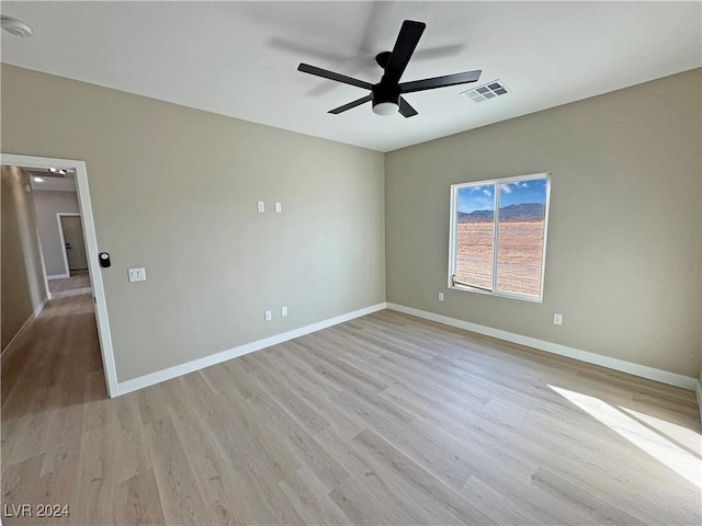 empty room with light hardwood / wood-style flooring and ceiling fan