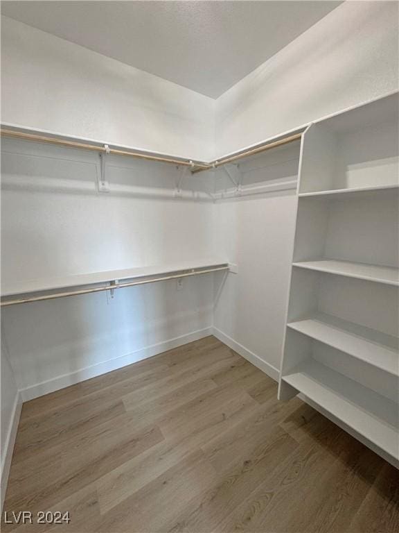 walk in closet featuring hardwood / wood-style floors