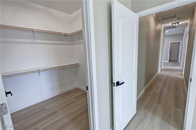 spacious closet with light hardwood / wood-style floors