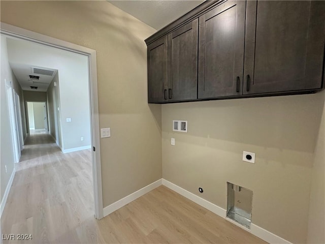 washroom featuring electric dryer hookup, cabinets, hookup for a washing machine, and light hardwood / wood-style flooring