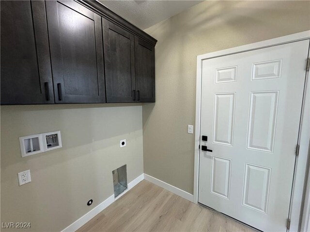 laundry room with electric dryer hookup, hookup for a washing machine, cabinets, and light hardwood / wood-style floors