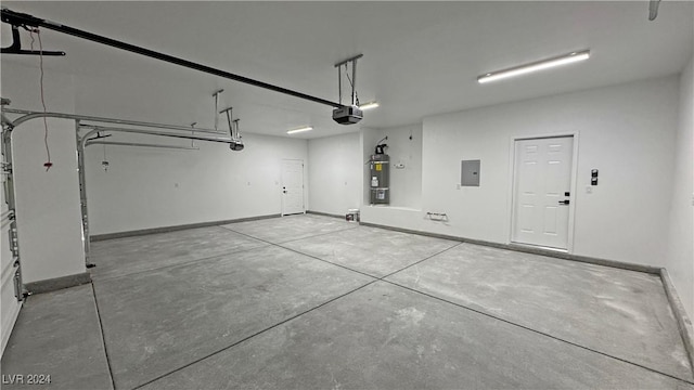 garage featuring strapped water heater, a garage door opener, and electric panel