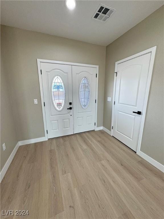 foyer entrance with light wood-type flooring