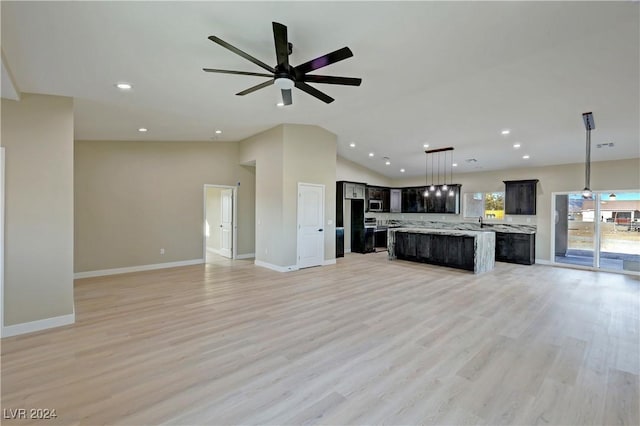 kitchen with ceiling fan, a center island, pendant lighting, and light wood-type flooring