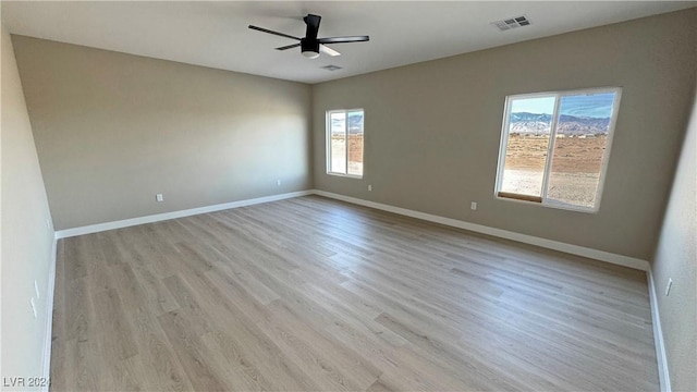 unfurnished room featuring ceiling fan and light wood-type flooring