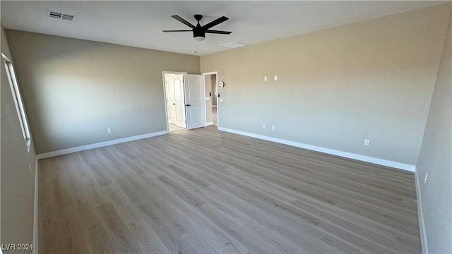 spare room featuring ceiling fan and light hardwood / wood-style flooring