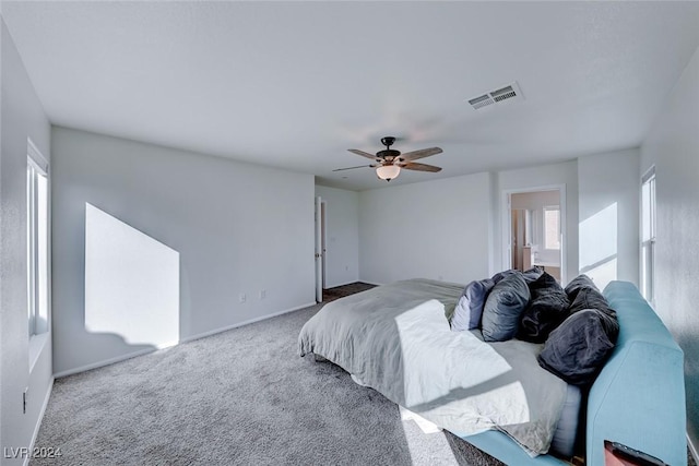 bedroom featuring carpet, ensuite bathroom, and ceiling fan