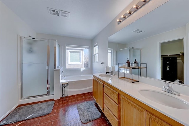 bathroom featuring vanity, independent shower and bath, and hardwood / wood-style flooring