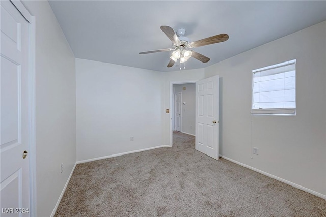 unfurnished bedroom featuring ceiling fan and light colored carpet