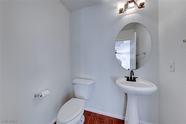 bathroom featuring hardwood / wood-style floors, toilet, and sink