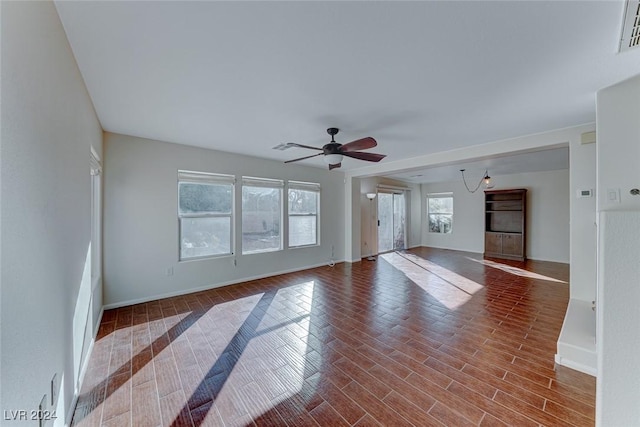 unfurnished living room with wood-type flooring and ceiling fan