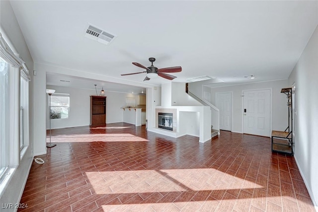 unfurnished living room featuring ceiling fan and wood-type flooring