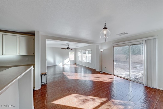 unfurnished room featuring wood-type flooring, a textured ceiling, and ceiling fan