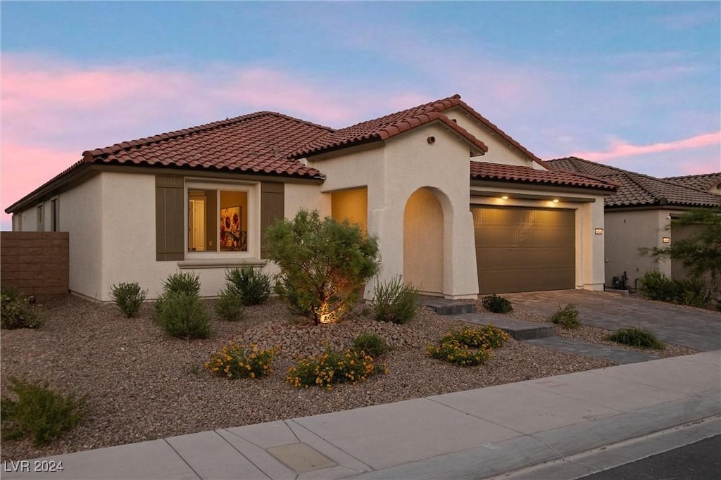 mediterranean / spanish-style house featuring a garage