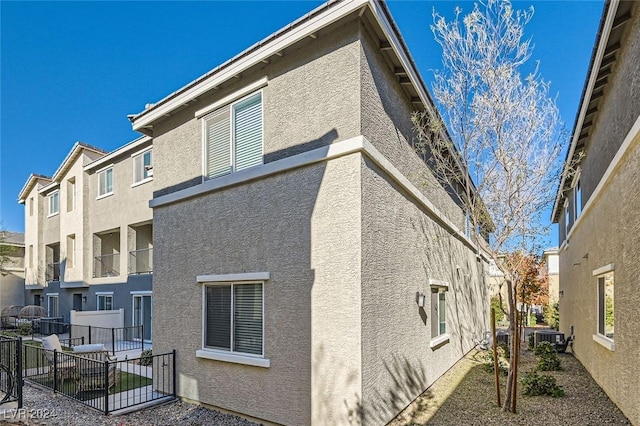 rear view of house featuring central air condition unit