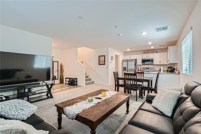 living room featuring light carpet