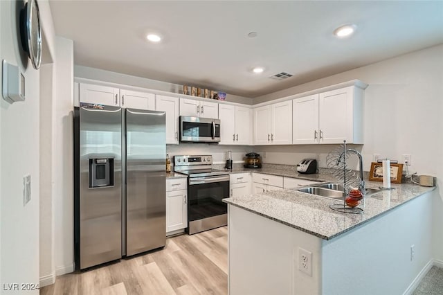 kitchen featuring white cabinetry, sink, and appliances with stainless steel finishes