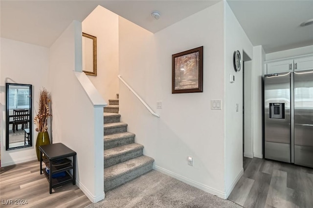 stairway featuring hardwood / wood-style flooring