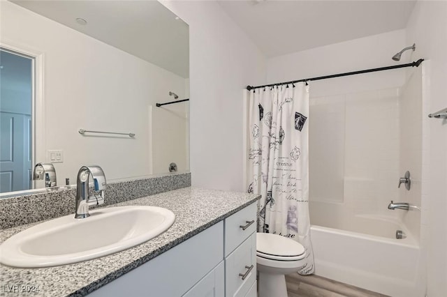 full bathroom with hardwood / wood-style flooring, shower / bath combo, toilet, and vanity