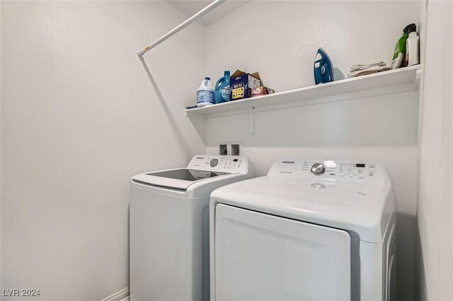 laundry room with washing machine and clothes dryer