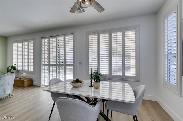 dining room with ceiling fan and light hardwood / wood-style flooring