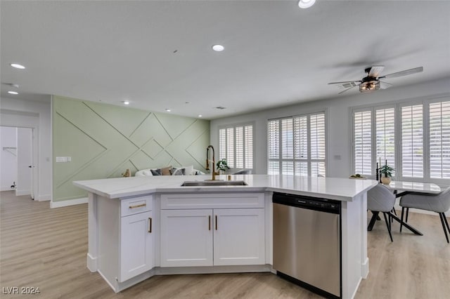 kitchen featuring white cabinets, dishwasher, sink, and a wealth of natural light