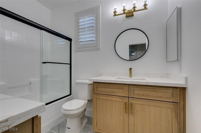 full bathroom featuring toilet, vanity, tile patterned floors, and enclosed tub / shower combo