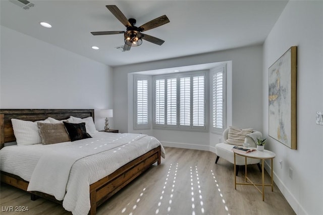 bedroom with hardwood / wood-style floors and ceiling fan