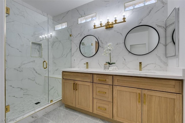 bathroom with tile patterned flooring, vanity, tile walls, and a shower with shower door