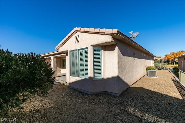 view of side of property with central AC