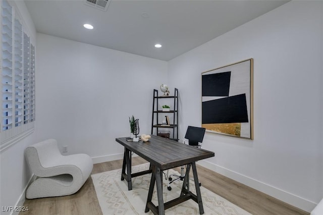 office space with light wood-type flooring