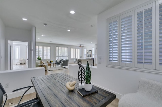 dining room with ceiling fan and light hardwood / wood-style floors