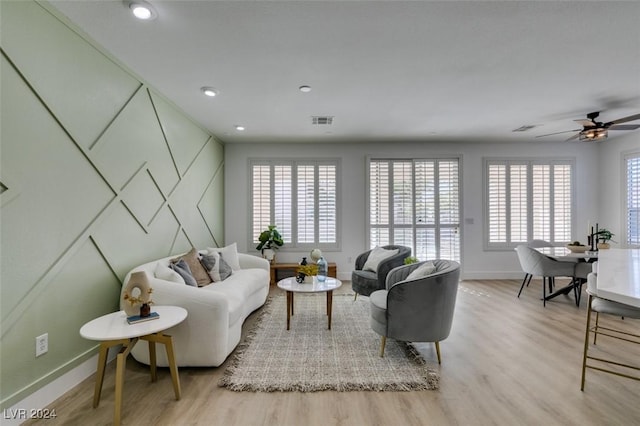 living room with ceiling fan and light hardwood / wood-style floors