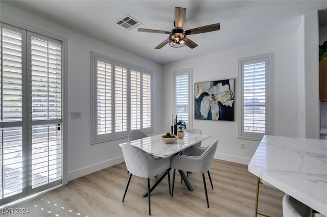 dining area featuring ceiling fan, plenty of natural light, and light wood-type flooring