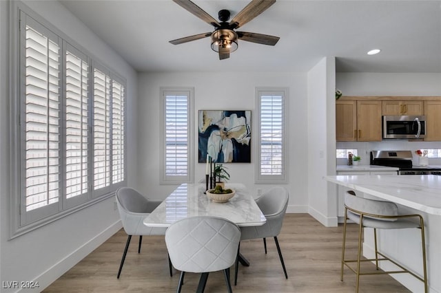 dining area featuring ceiling fan and light hardwood / wood-style flooring