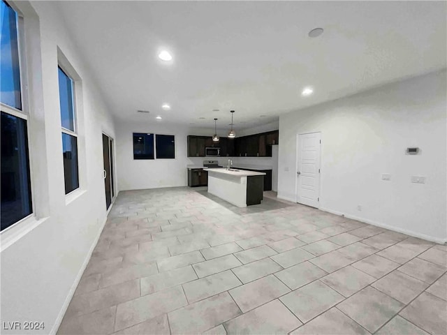 kitchen featuring light tile patterned floors, a center island, and sink