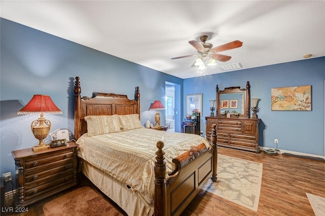 bedroom with wood-type flooring and ceiling fan