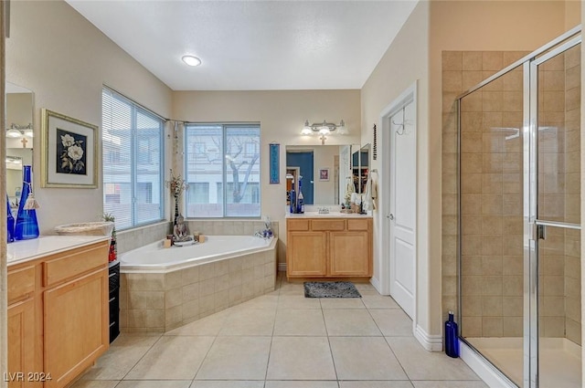 bathroom featuring tile patterned flooring, vanity, and shower with separate bathtub