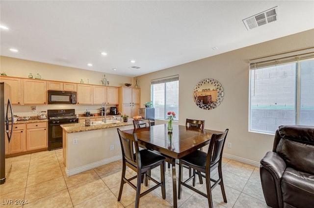 dining space with light tile patterned flooring and sink