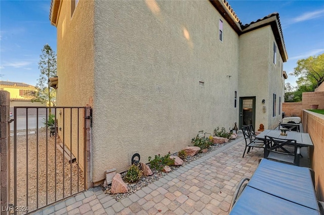 view of side of home with a patio