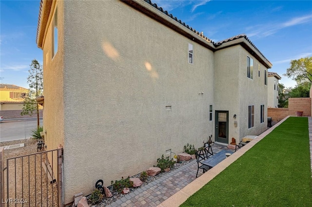 rear view of property featuring a patio area and a yard