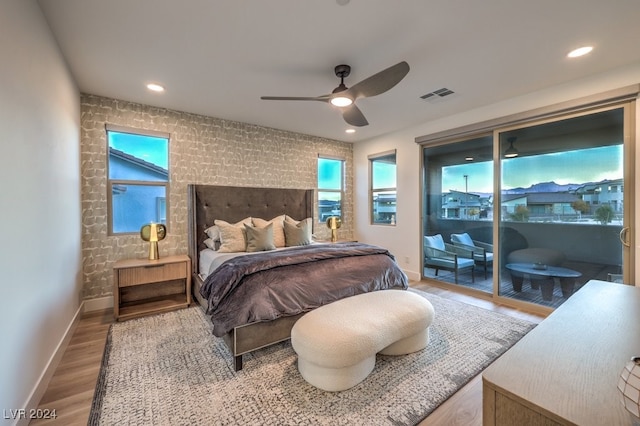 bedroom featuring access to outside, ceiling fan, and light hardwood / wood-style floors