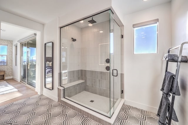 bathroom featuring wood-type flooring and a shower with door