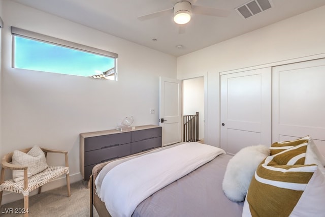 carpeted bedroom with a closet and ceiling fan