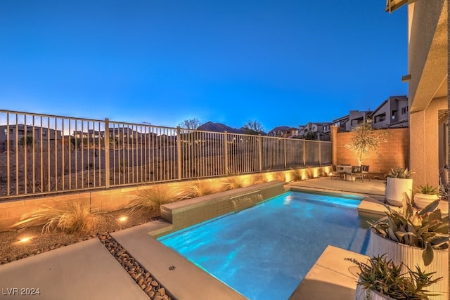 pool at dusk featuring a patio area