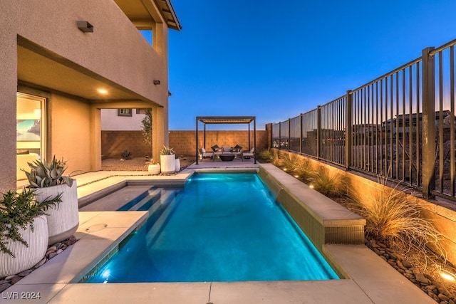 pool at dusk with outdoor lounge area and a patio area