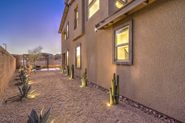 property exterior at dusk with a patio area