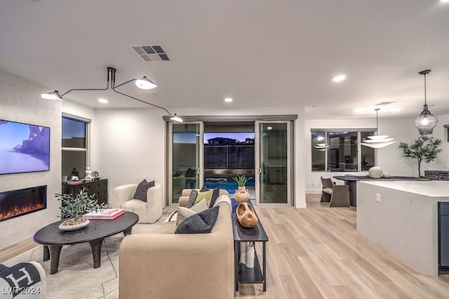 living room with a fireplace and light hardwood / wood-style floors