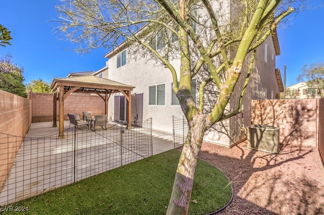 back of property with a gazebo, a patio, and central AC unit